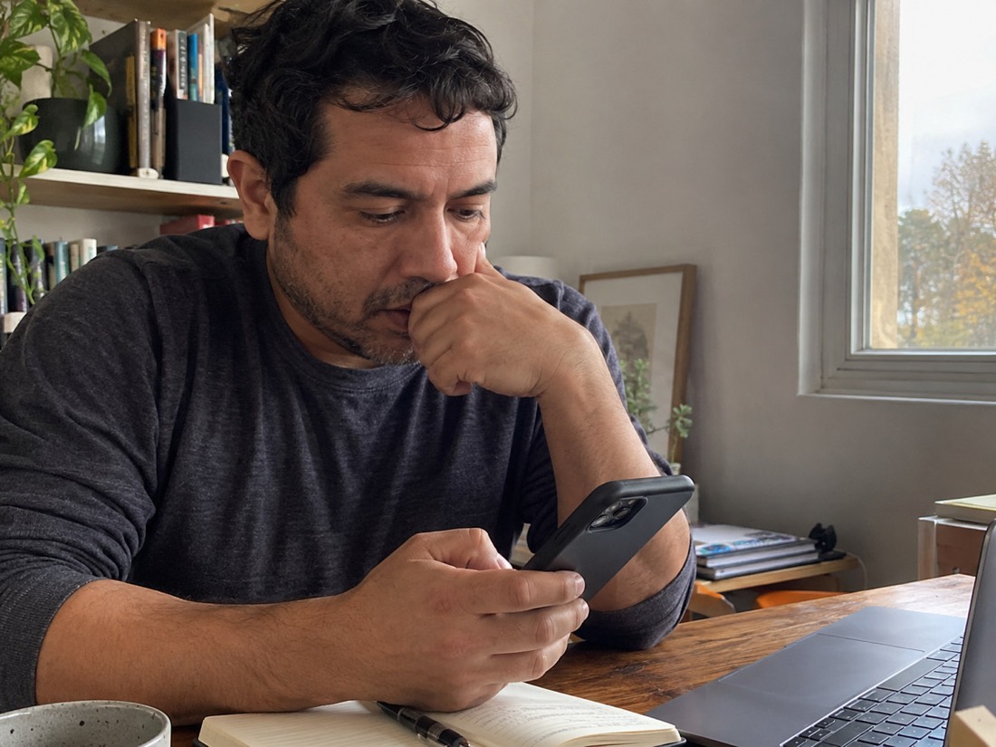 Person using a laptop and notes during a job search