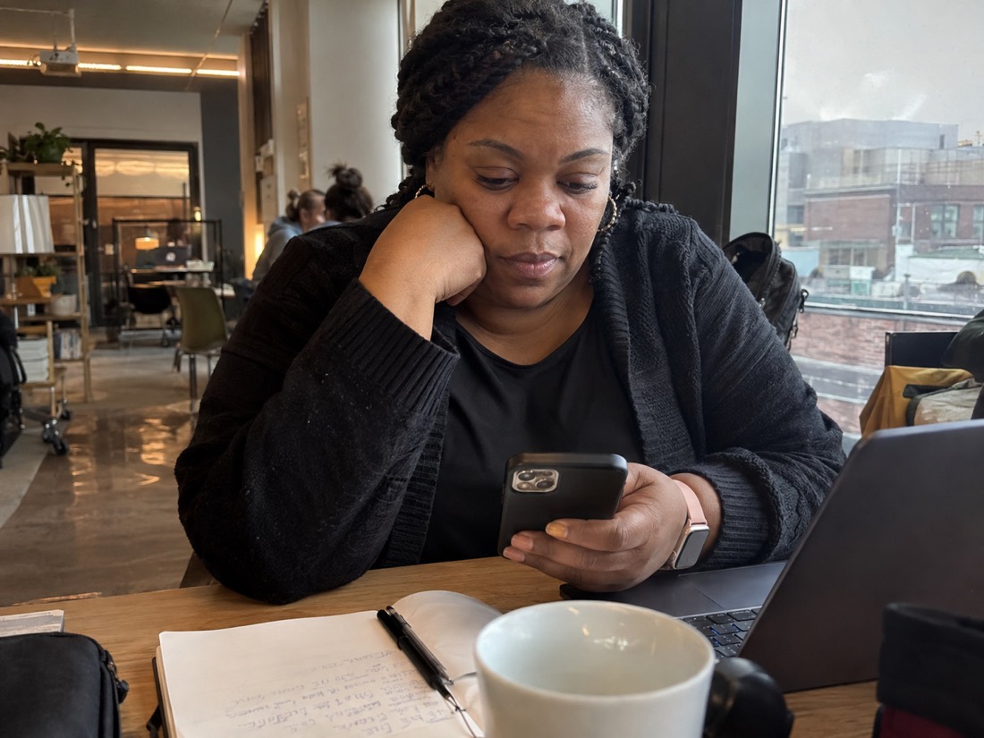 Person reviewing job search materials while using a laptop