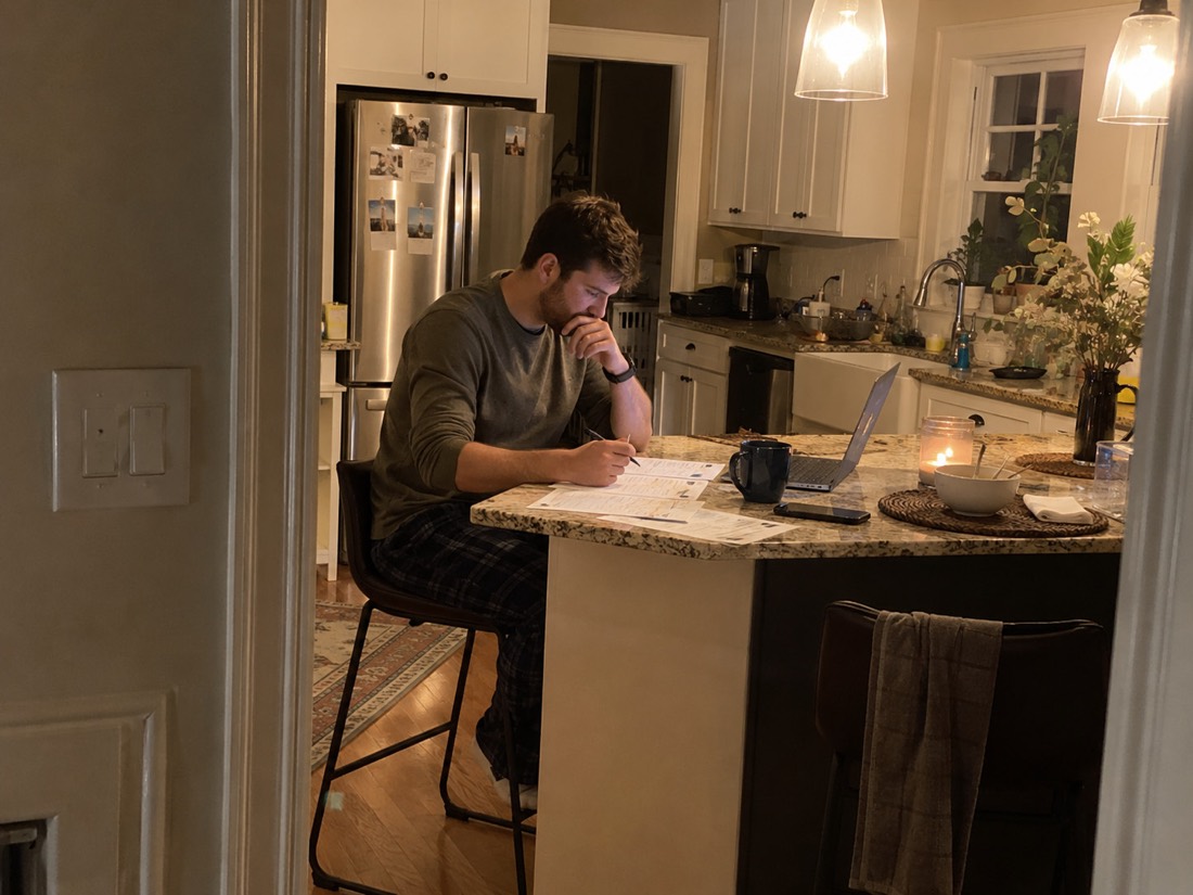 Person using a laptop and notes during a job search