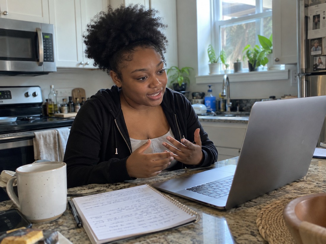 Person reviewing job search materials while using a laptop