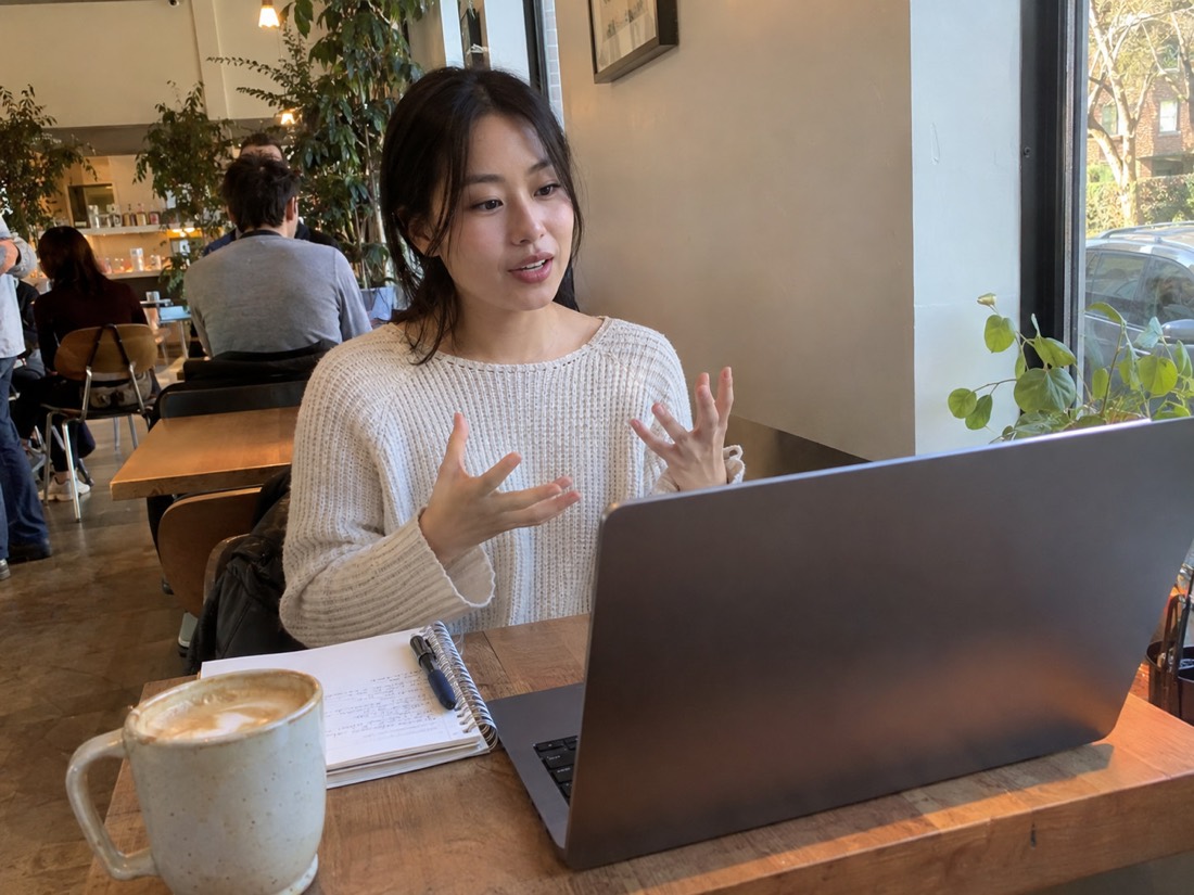 Person reviewing job search materials while using a laptop
