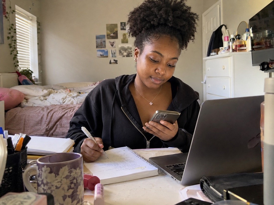 Person reviewing job search materials while using a laptop