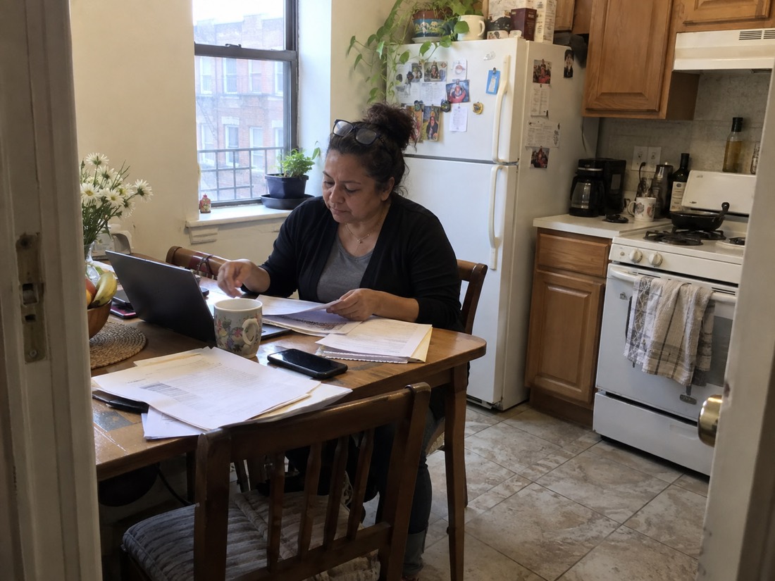 Person using a laptop and notes during a job search